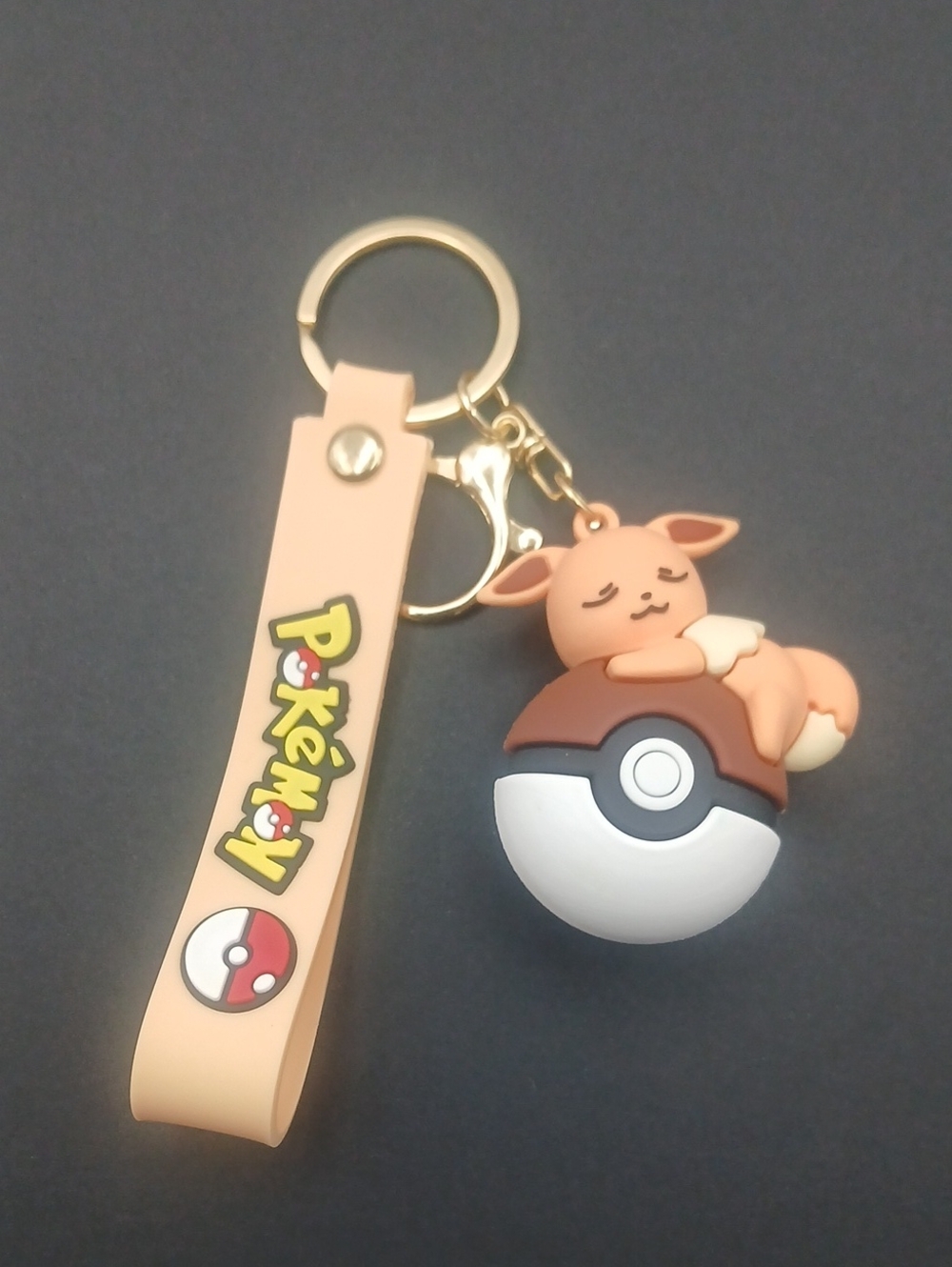 Pokemon Eevee Resting On A  Pokeball Keychain With Wrist Strap